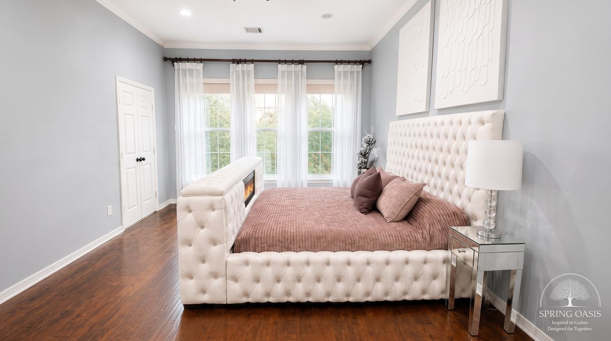 Primary bedroom with a tufted king bed