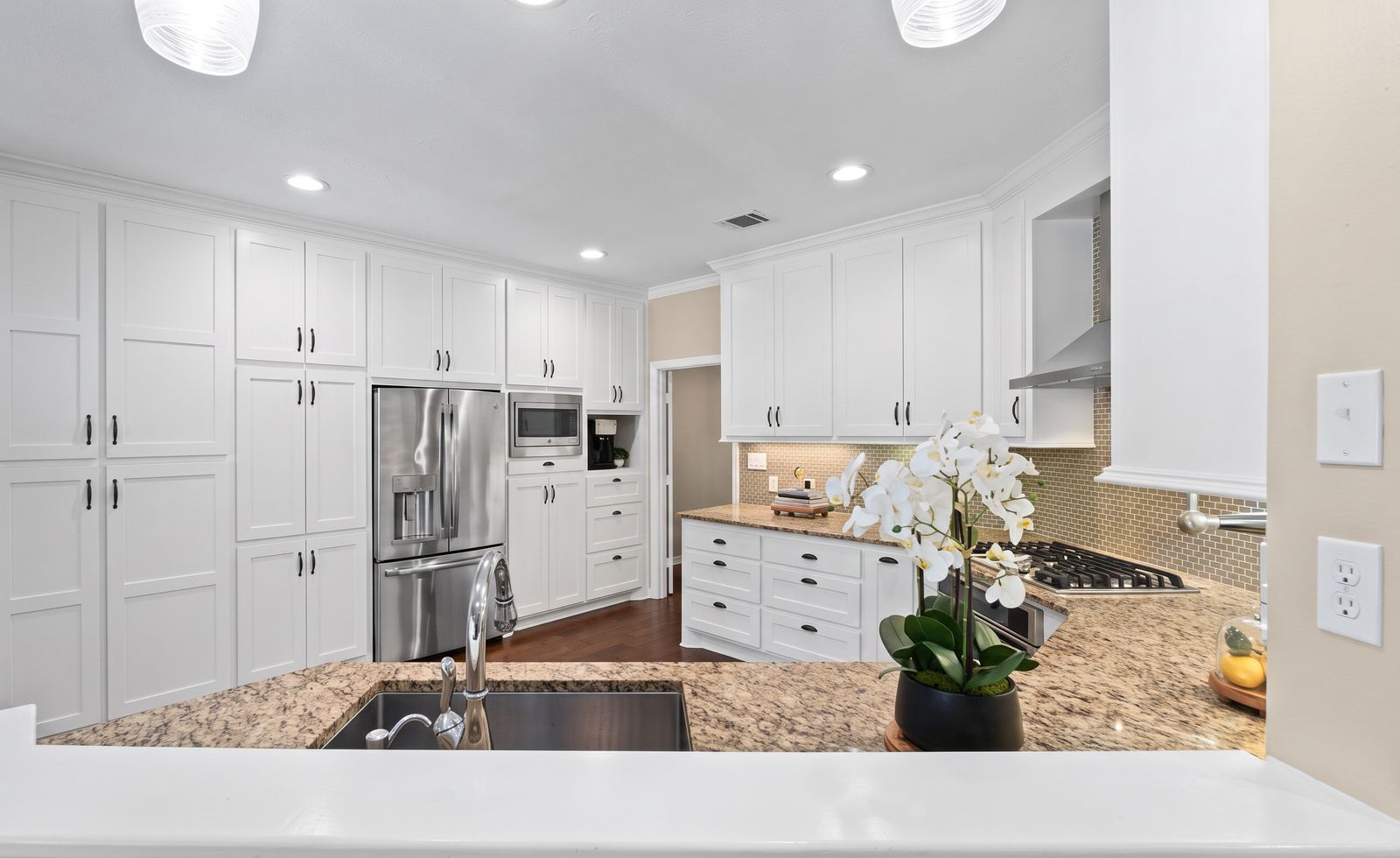 Kitchen with white cabinetry, granite counters and stainless appliances