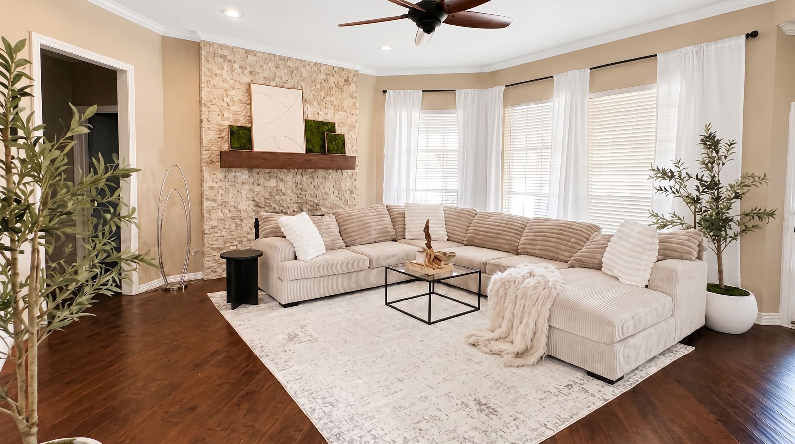 Living room with a sectional sofa and stone accent wall